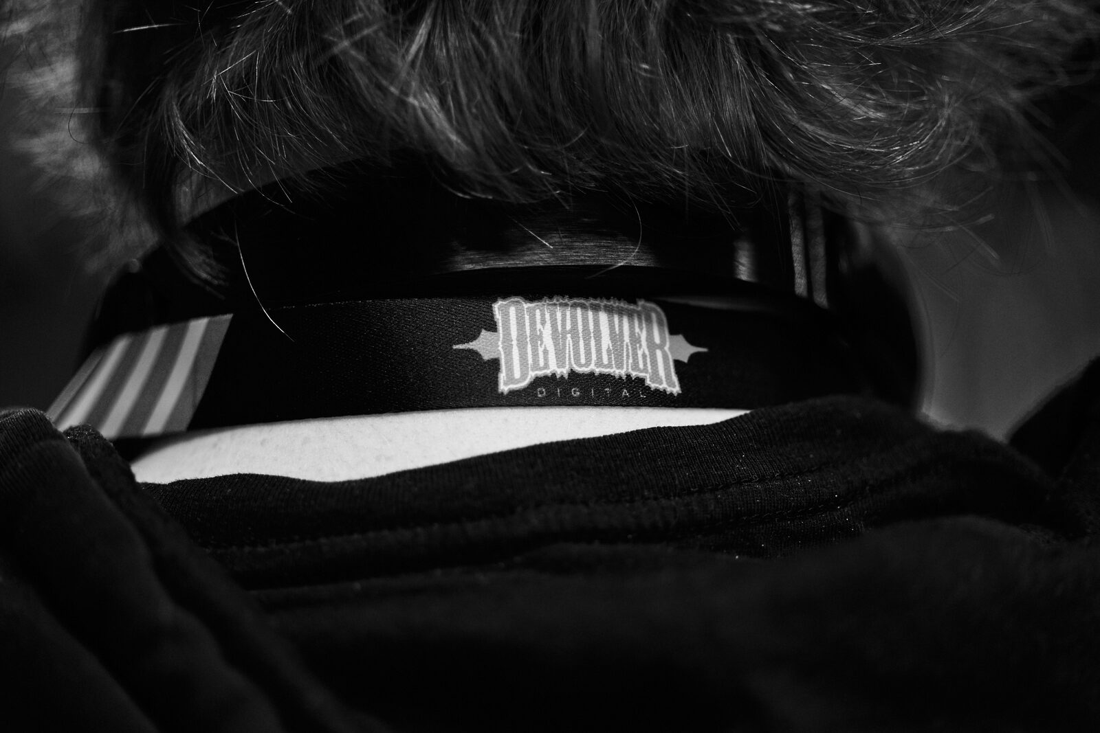 Close crop on the back of an attendee's head, wearing a Devolver Digital cap.