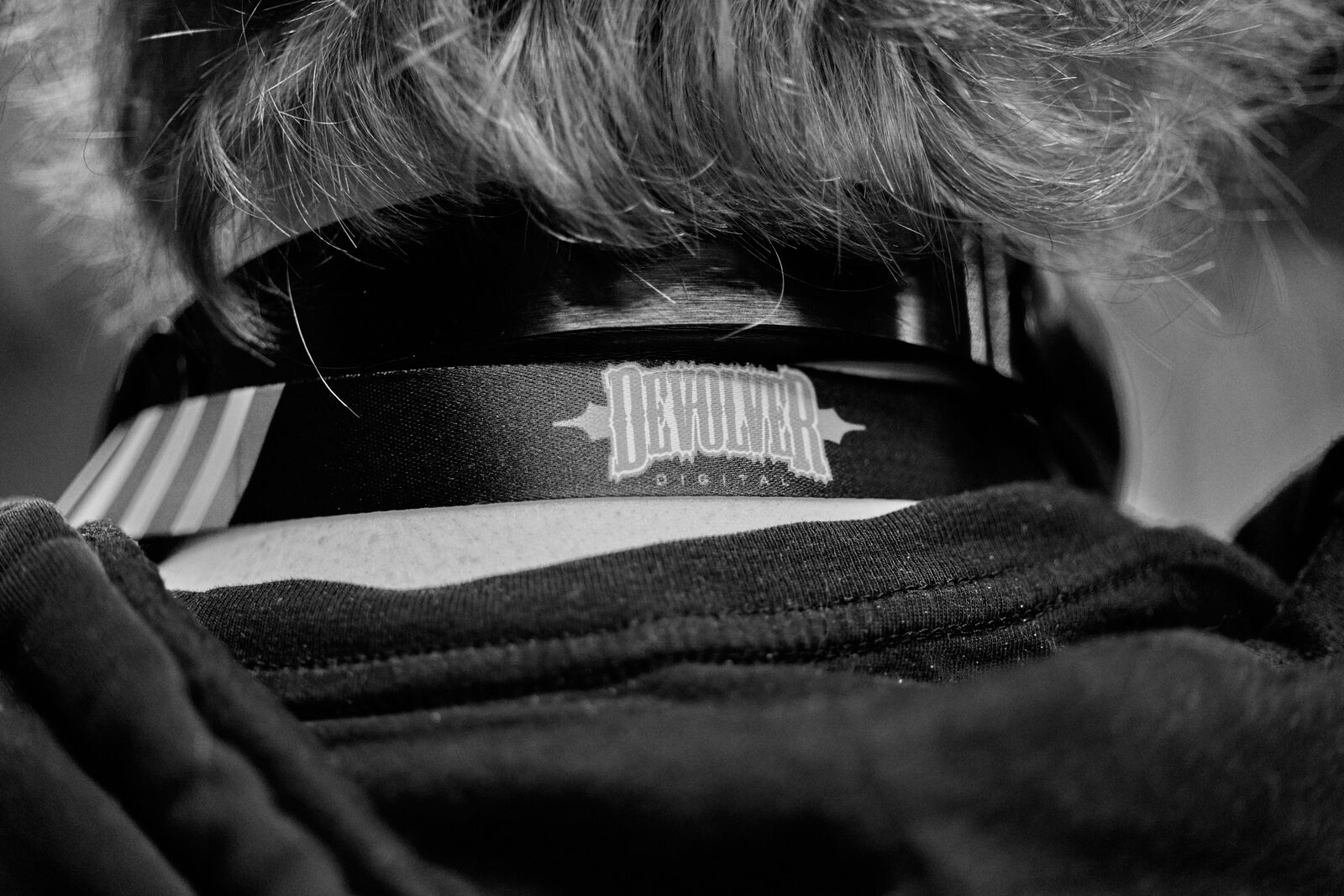 Close crop on the back of an attendee's head, wearing a Devolver Digital cap.